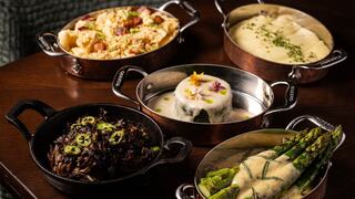 A selection of gourmet dishes including creamy mashed potatoes, flavorful rice, sautéed asparagus, and a delicate vegetable mélange.