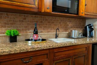 A cozy room features soft lighting, elegant furnishings, and a welcoming atmosphere with a view of the outdoors and stylish decor.