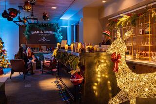 Logo featuring "Oak & Ember Speakeasy," established in 2025, set against a green background with a cozy, rustic vibe.